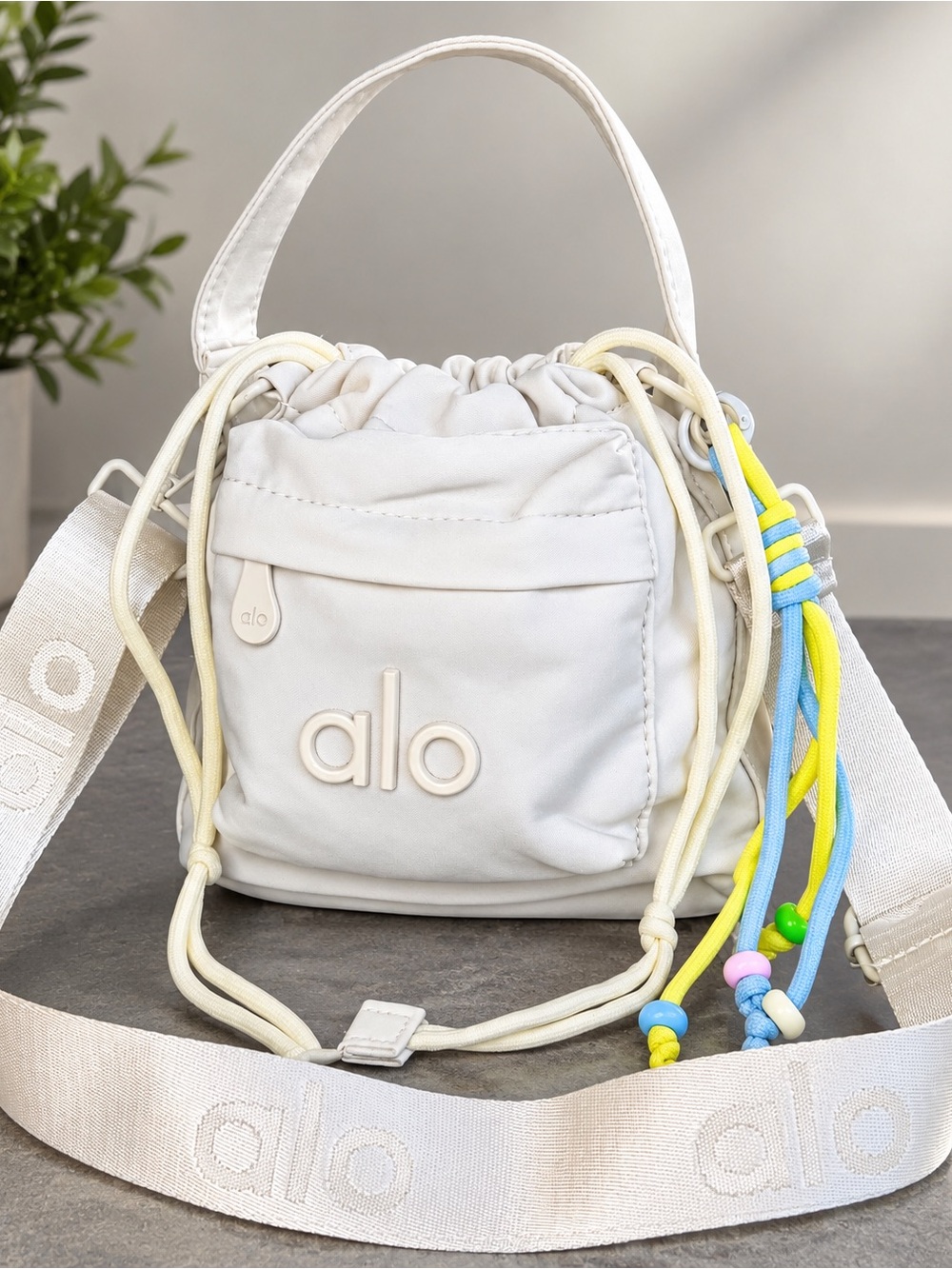 ALO Yoga women Cream Drawstring Crossbody with Blue and Yellow Bead Accents